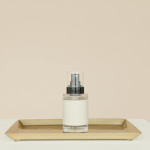 White and Silver Bottle on Brown Wooden Tray